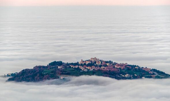 San Marino rising above the clouds